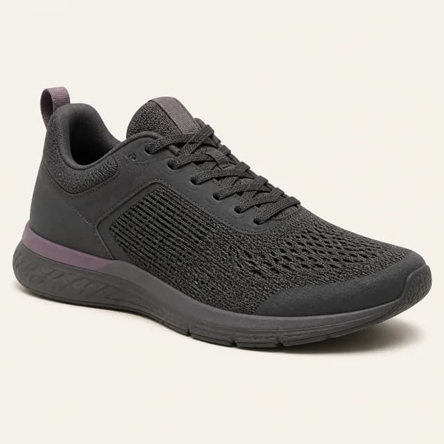 Charcoal knit training shoe with a muted violet detail, shown from a three-quarter side view